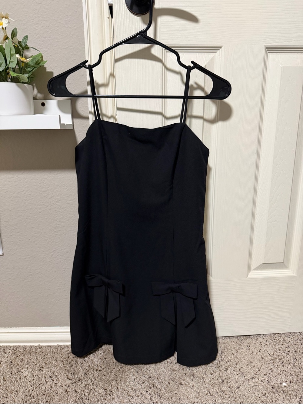 Altard State mini black dress with bows, built in shorts and adjustable straps.